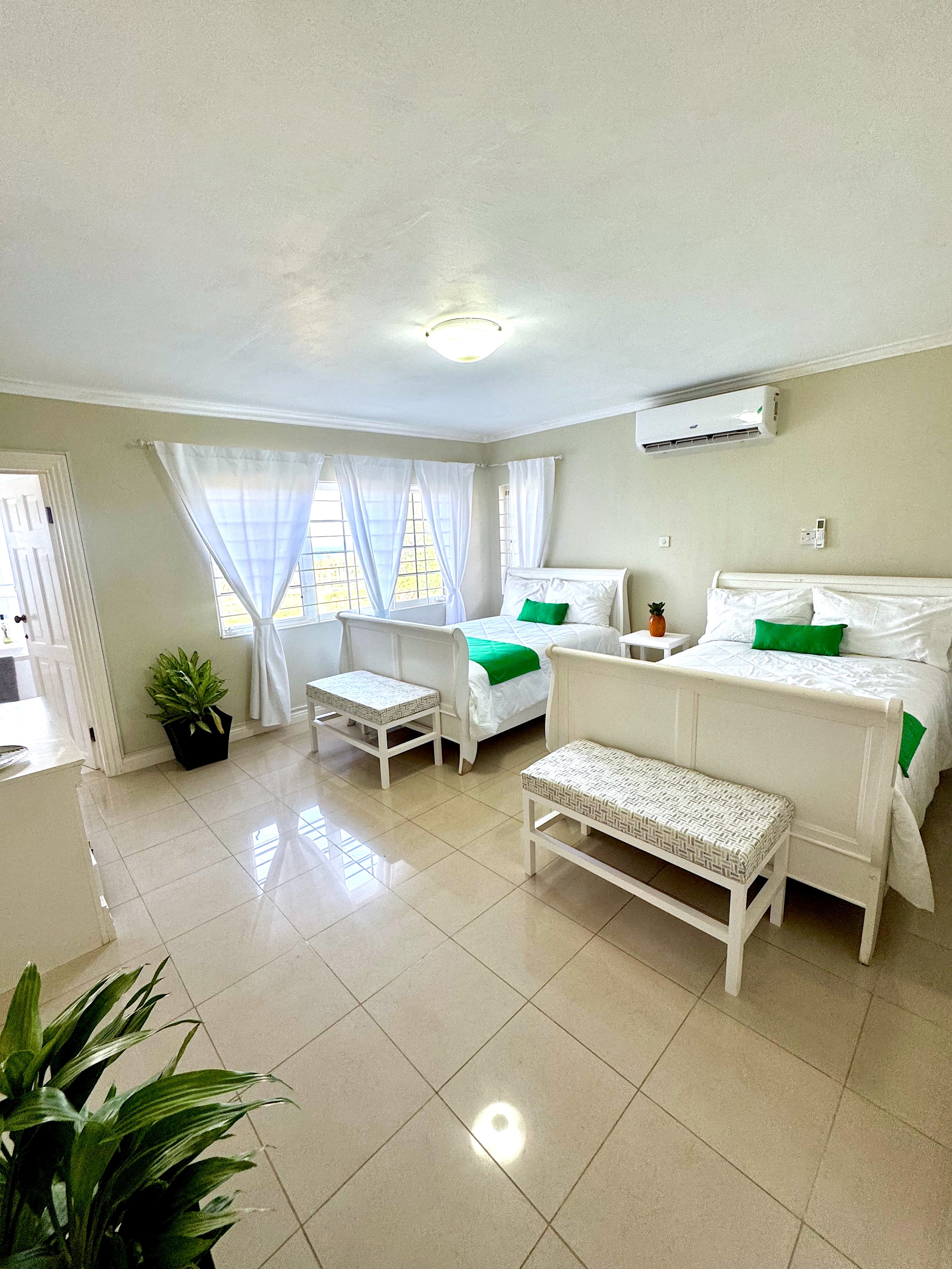Sweet Dreams Villa suite with white beds and green accents